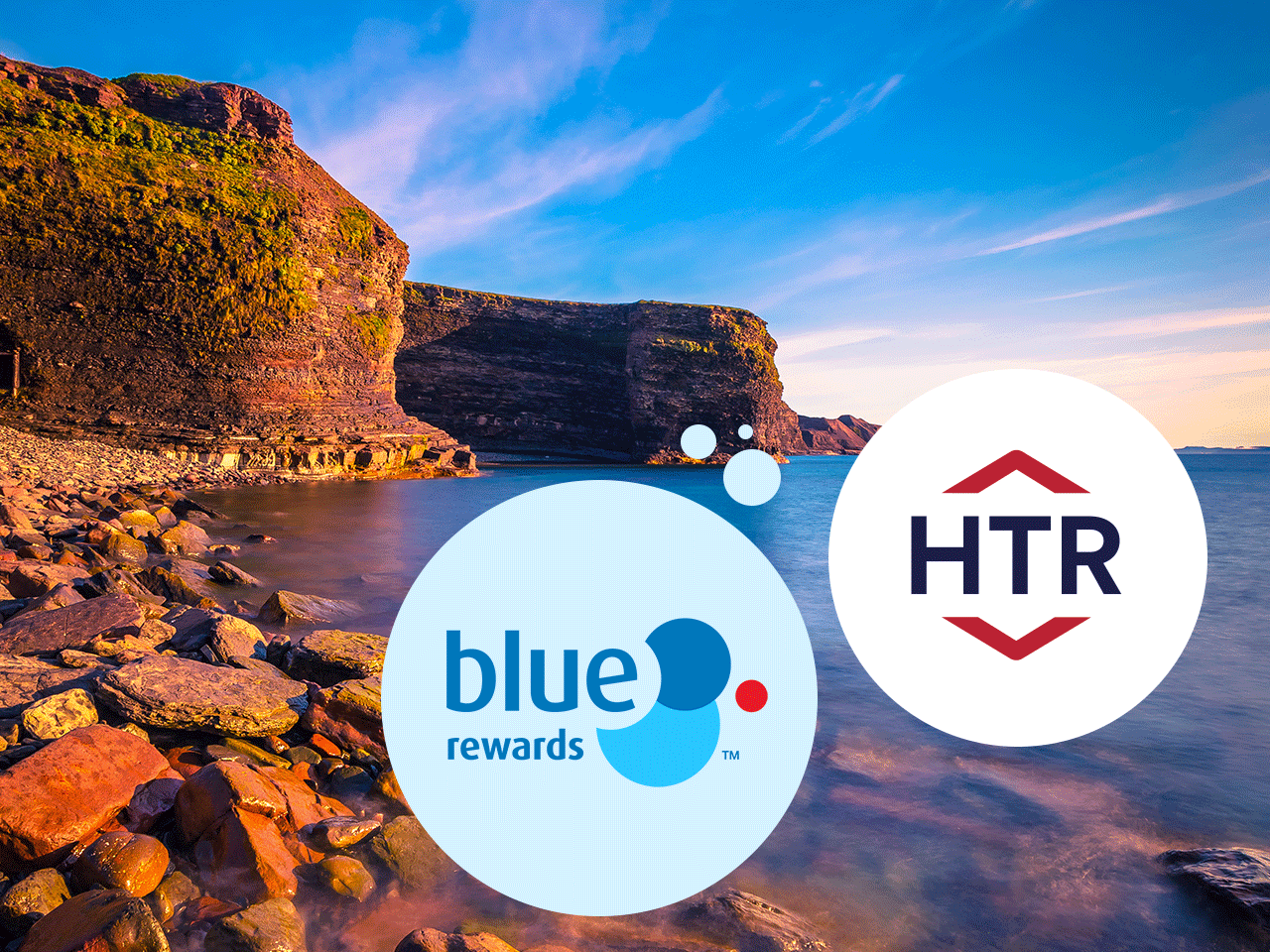 Rocky coastal cove at sunset with calm blue water and steep cliffs; overlaid circular logos for “blue rewards” and “HTR.”